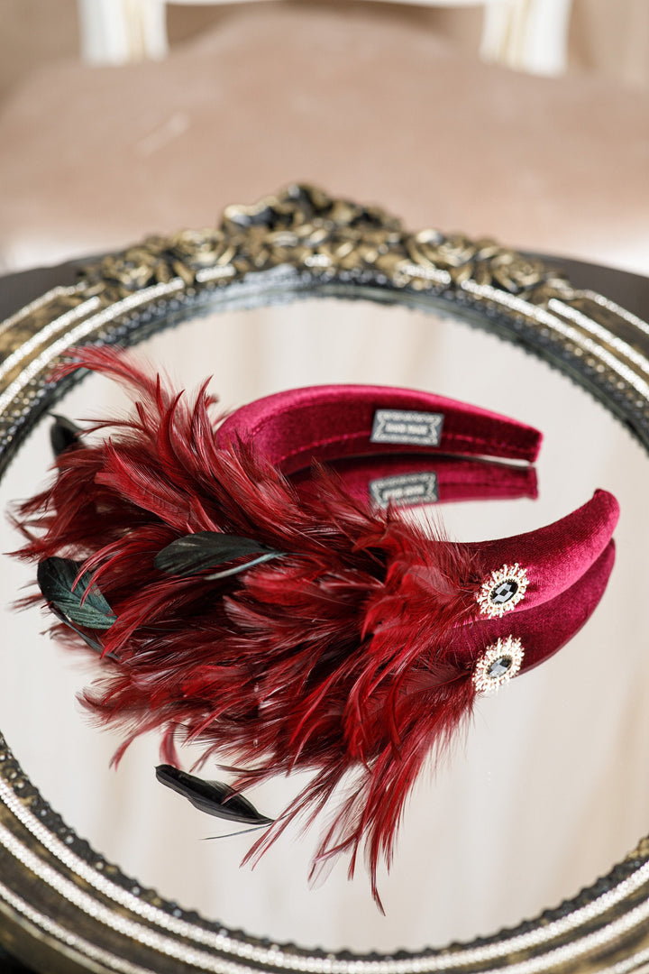 Burgundy fascinator with feather