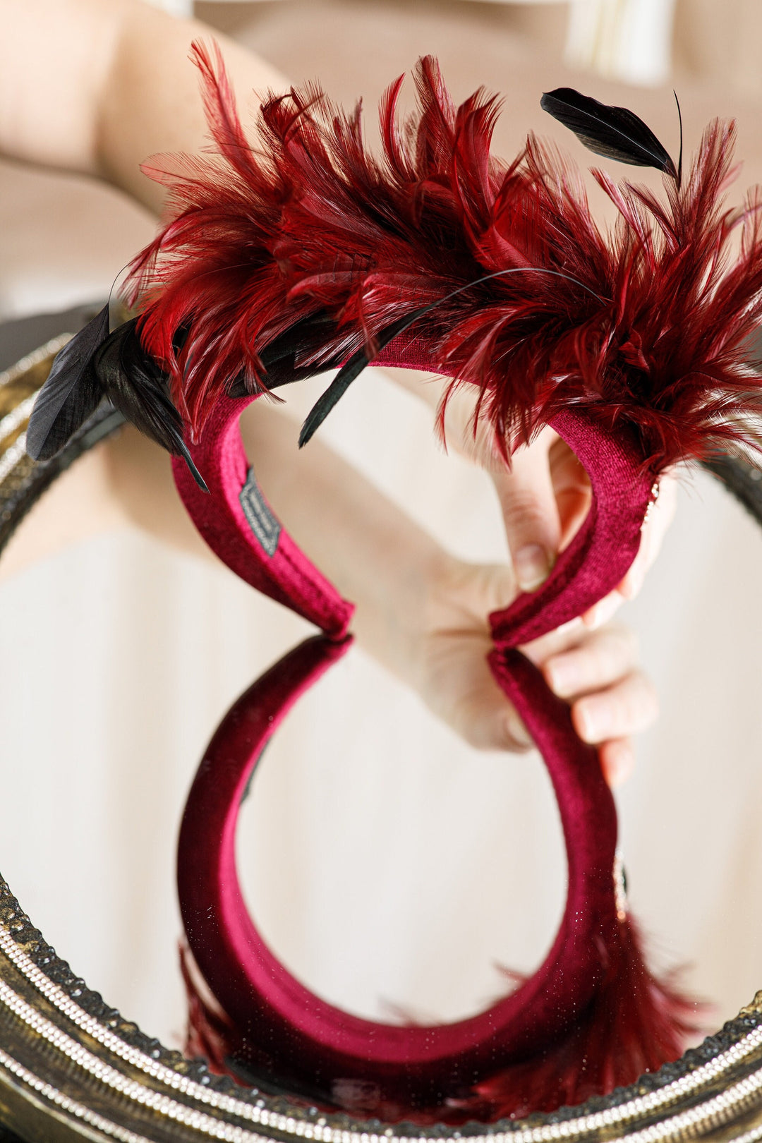 Burgundy fascinator with feather